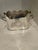 Vintage silverplated wine caddy with scalloped edges and elaborate handles. There are engraved heraldic shields on the...