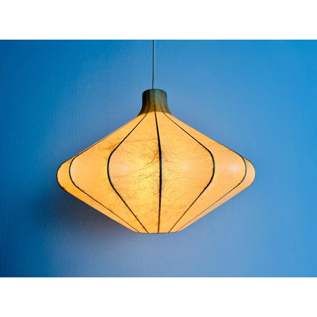 A cocoon pendant lamp made in Italy in the 1960s. The hanging lamp has been manufactured in the design of the lamps made...