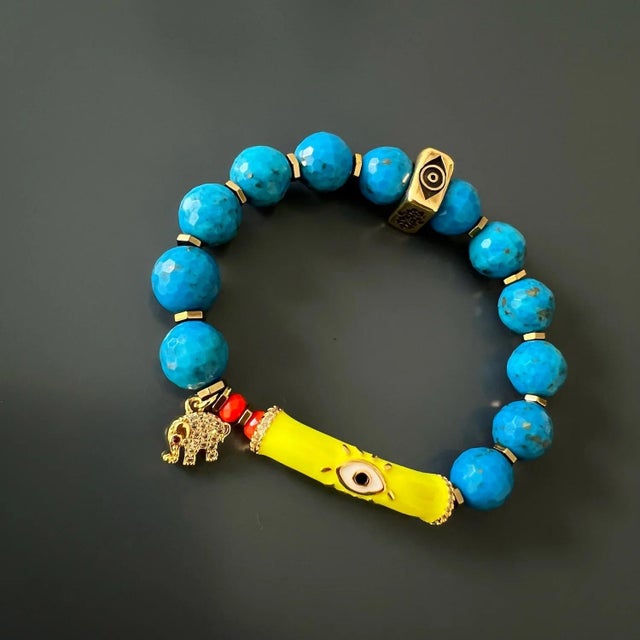 The Evil Eye & Elephant Turquoise Stone Beaded Bracelet is a one-of-a-kind piece of handmade jewelry that combines natural...