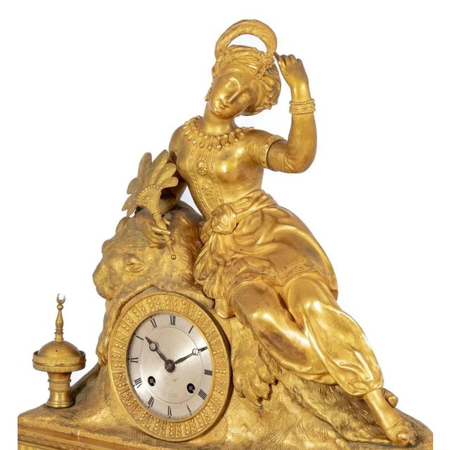 Charles X Gilt Bronze Figural Mantel Clock, circa 1830, the circular silvered dial, with strike on bell movement,...