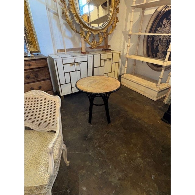 This vintage Italian table features a black lacquered finish. The top of the table is adorned with inscribed letters,...