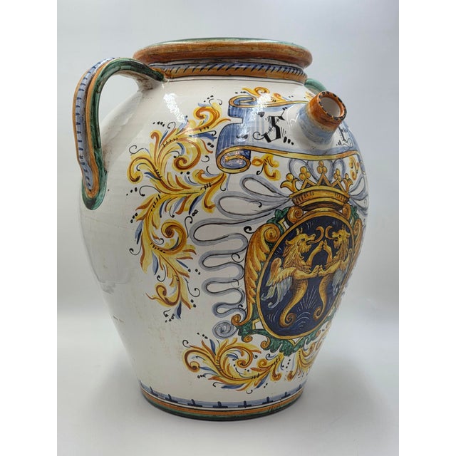 Antique 19th century Italian Majolica olive oil storage jar with a hand-painted heraldic shield featuring two winged lions...