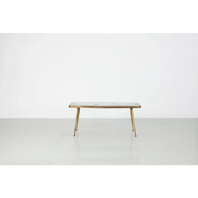 This mosaic table was designed in the 1950s in Germany by Berthold Müller. The table top is in pastel shades of green,...