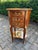 A refined pair of 1960 French Louis XVI-style mahogany commodes, richly decorated with marquetry inlay and gilded bronze...