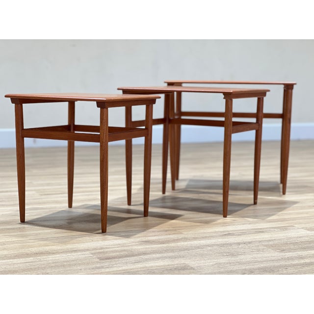 A set of three exquisite nesting tables, masterfully designed by johannes andersen in denmark during the 1960s. Crafted...