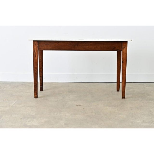 Dating to circa 1870, this 19th-century butcher shop or bakery display table features a lightly patinated white marble top...