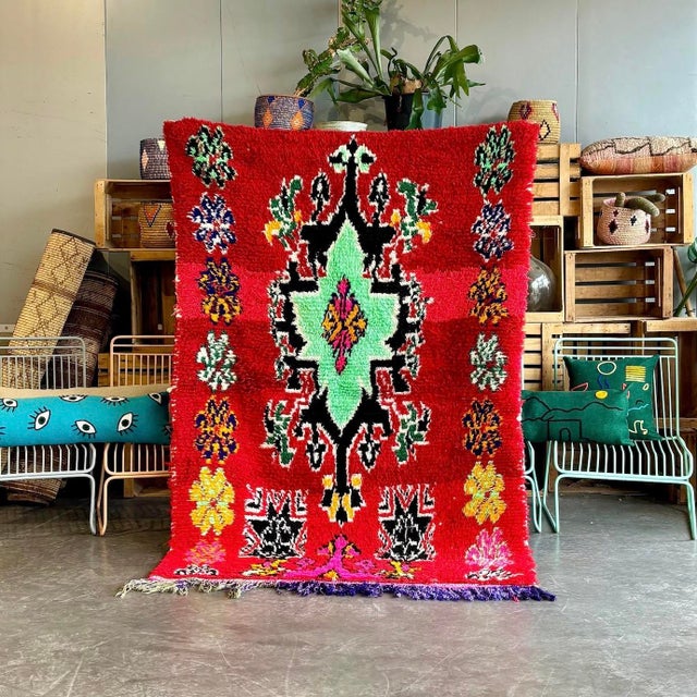 Immerse yourself in the rich tapestry of Moroccan culture with this exquisite Vintage Moroccan Berber Boucherouite Rug....