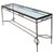 A console table crafted from iron with a dark patinated finish, topped with a glass surface. The clean, linear frame is...