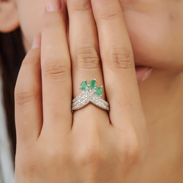 This Victorian-inspired crown cocktail ring features a graceful floral design centered with 1.14 carats of pear-cut...