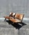 A sculptural pair of contemporary safari lounge chairs featuring rich hair-on-hide upholstery over dark stained wood...