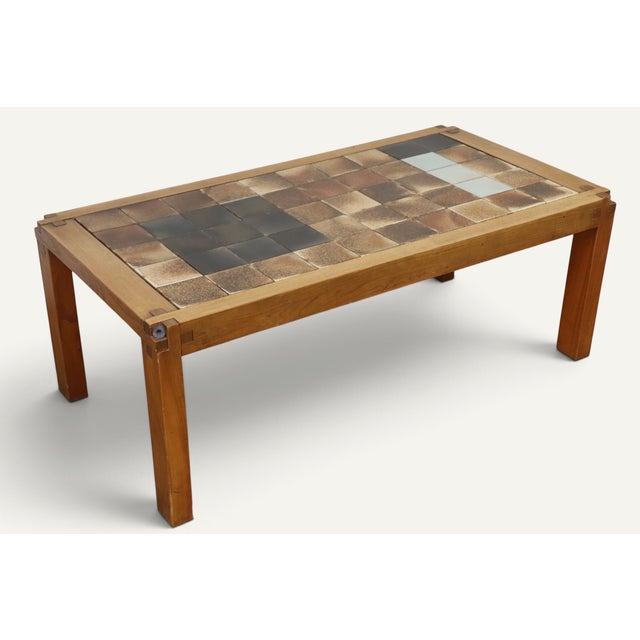 A beautiful French coffee table designed by Pierre Chapo in the 1960s. Made of elm, it features a striking ceramic tile...