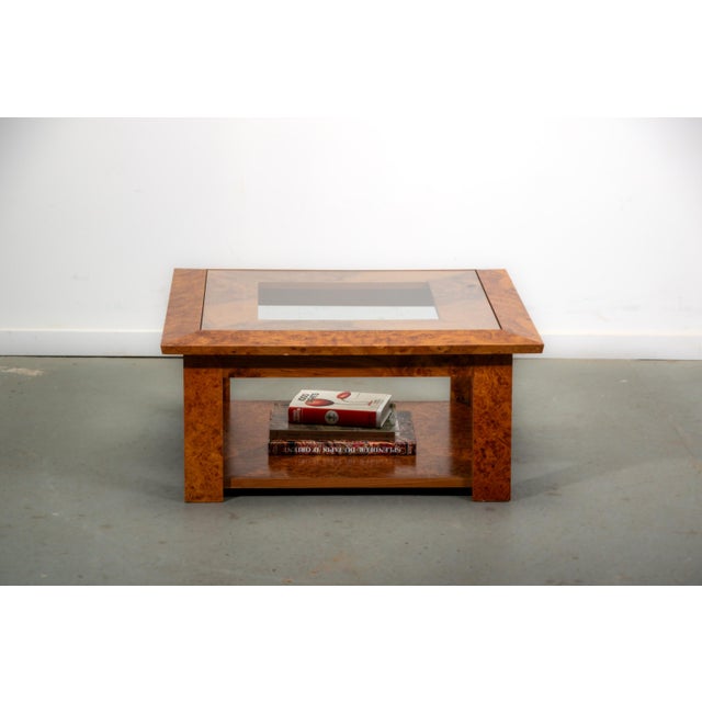 Compact coffee table made from walnut burl veneer with a glas top. The table features a useful shelf that make it...