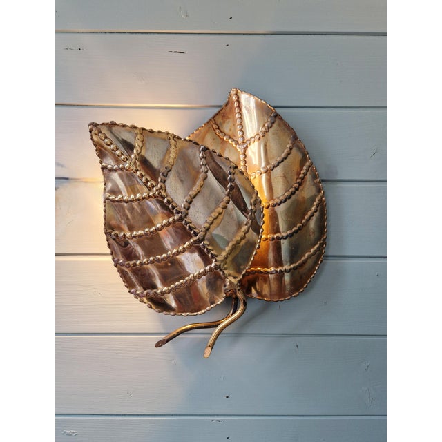 French sculptural wall sconce with two leaves in solid brass, handcrafted and welded, circa 1970. In the style of Maison...