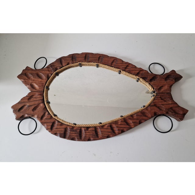 A 1960s Spanish mirror with a strong character, crafted from hand-carved solid wood with an interior frame of natural rope...