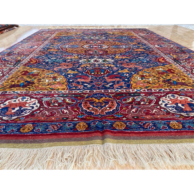 This vintage rug is hand-knotted in wool, woven in the Kashan Persian design tradition — specifically the Shikargah, or...