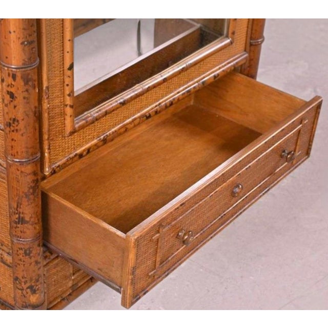 This is a Victorian Aesthetic Movement style burnt bamboo armoire cabinet crafted for Bloomingdale’s in the later part of...