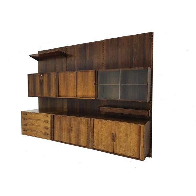 Large rosewood wall unit with rosewood back plates from 1950s. The cabinet has some traces of use like stains, but no...