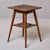 This two-tier occasional table features a square top and a smaller square lower shelf, both densely chip-carved in a...