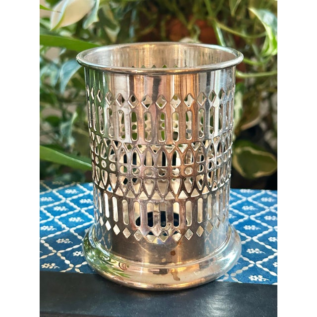 Add old world charm to your table setting with this silver plate over copper condiment holder or jar sleeve. From the...