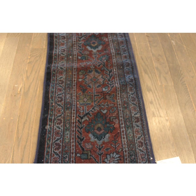 A beautiful Vintage Heriz Handmade Wool Rug with a red field and multicolor accents in allover geometric medallion design....