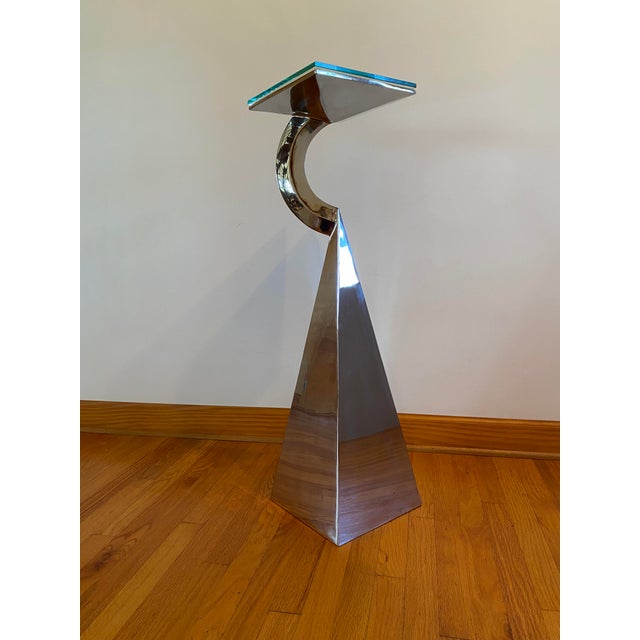 This pedestal table is made from stainless steel. The top of the table is covered by a piece of 3/8" tempered glass. The...