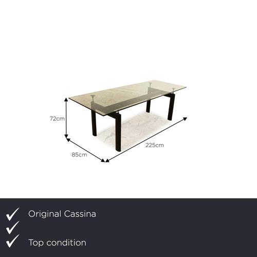 The Le Corbusier LC 6 dining table from Cassina consists of a glass top and stands on black feet. It is characterized by...