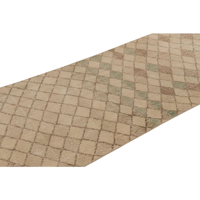 This vintage rug is a 3x8 Turkish distressed piece, made with hand-knotted wool circa mid-20th century. It is an exciting...