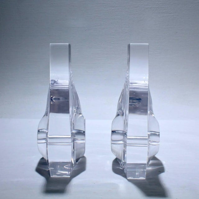 A good pair of Ritts Astrolite Lucite bookends. With an abstract, modernist design with pierced central openings. Height:...