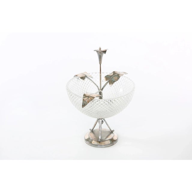 North American silver plated holding base with lily flower design details / cut crystal centerpiece bowl. The piece is...