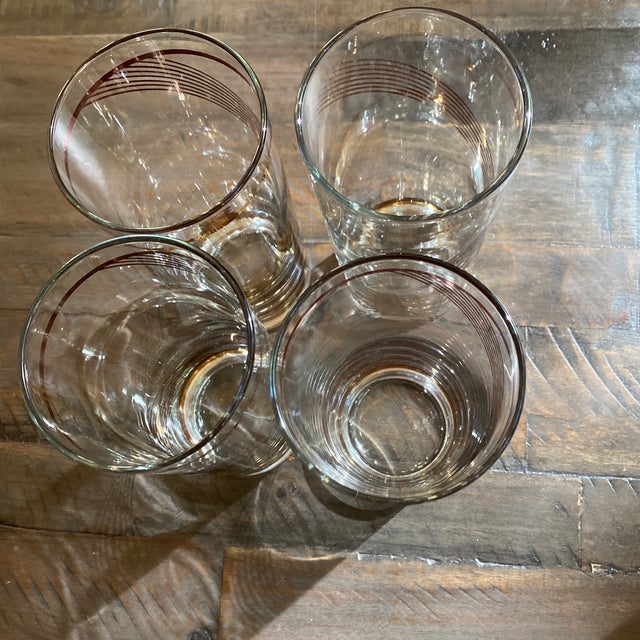 This set of Libby Mid-Century Modern highball glasses features a stunning gold swirl design that adds a touch of elegance...