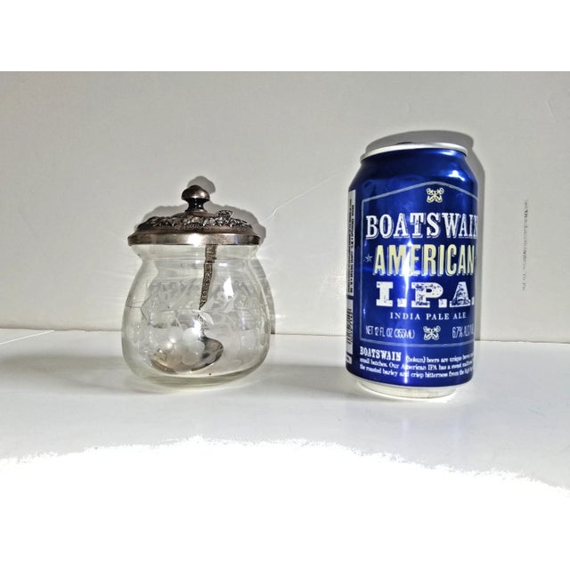Here is a beautiful repousse sterling art deco jam/condiment with a matching spoon! Would also work as a sugar bowl. The...