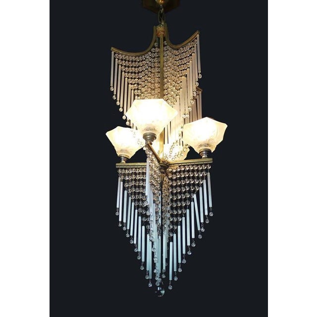 Elegant and very rare chandelier with four frosted shades in molded-pressed glass with glass beads and rods in the manner...