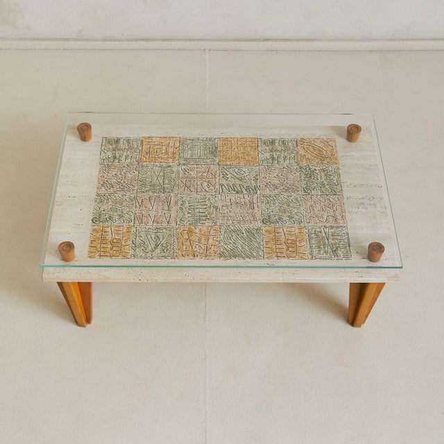 An artisan-made Italian coffee table from the 1970s, combining travertine, wood, and glass in a thoughtful composition....