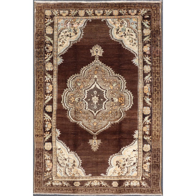 Measures: 6'9'' x 10'9''. This vintage Turkish Oushak rug, (circa mid-20th century) features a unique blend of colors and...