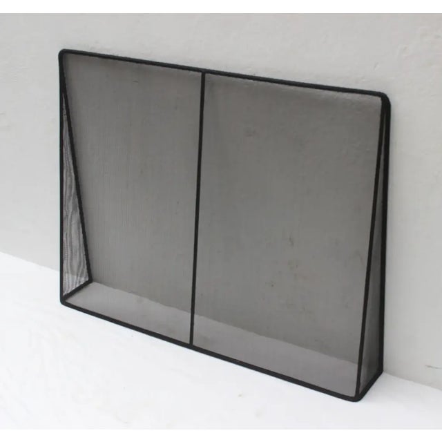 Handcrafted custom modern metal and wire mesh fireplace screen.