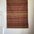 Large Indian striped rug with red, yellow, and white geometric friezes and a beige base, 185 x 136 cm. Weight: 3.1 kg....