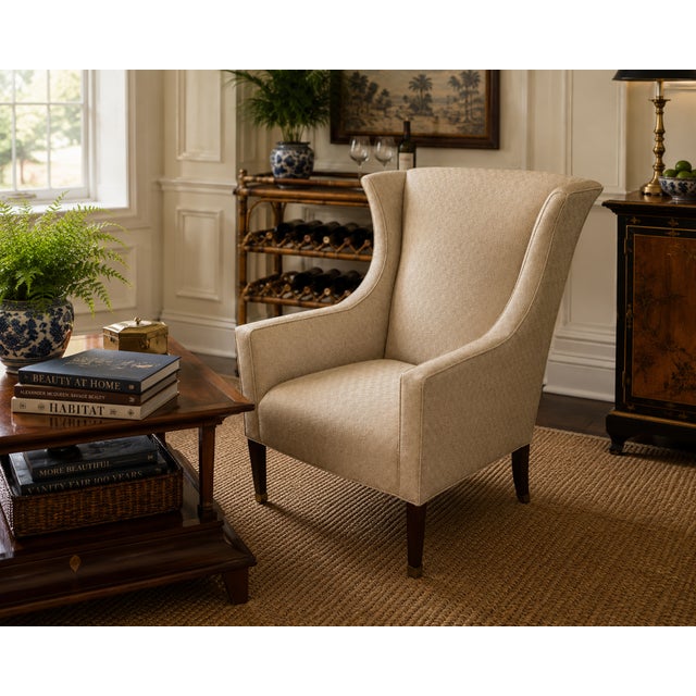 A study in refined craftsmanship, this wingback chair by Kravet exemplifies the sophistication of bespoke furniture...