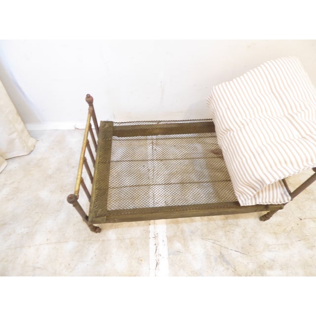This brass doll's bed on casters has a new handmade mattress. It could be used for a collection of toys or as a cat bed.