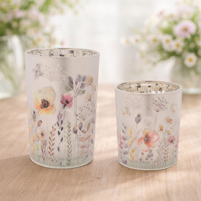 Bring warmth, light, and artistry into your home with this set of floral votive candle holders.These luminous matte silver...