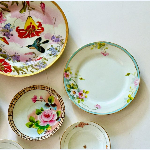 Set of 7 Antique Japanese and Mid-Century Chinese Hand‑Painted Floral Plates A lovely mixed collection of Japanese and...