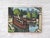 Oil on canvas depicting barges moored on the Seine, in a setting that is both wooded and urban. The artist presents an...