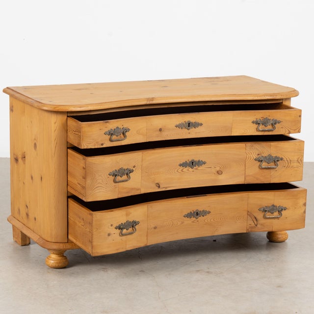 Danish chest of three drawers, crafted in pine with a warm waxed finish that enhances the natural color and character of...