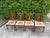 Vintage mid-century walnut dining chairs featuring distinctive sculpted backrests, tapered legs, and warm walnut tones....