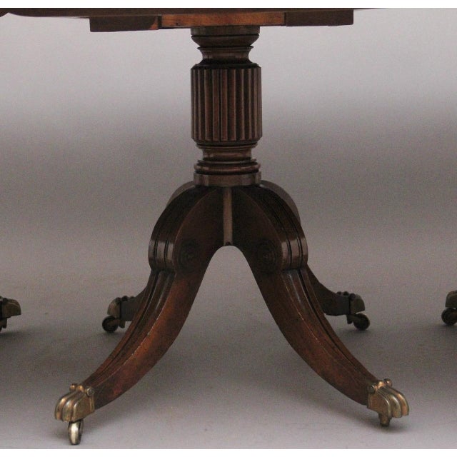 A large and impressive early 19th Century mahogany three pedestal dining table of exceptional quality, incorporating two...