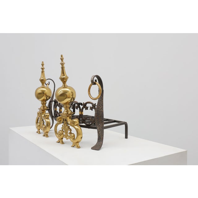 An elegant French fireplace set composed of a pair of polished brass andirons and an accompanying wrought iron fire grate,...