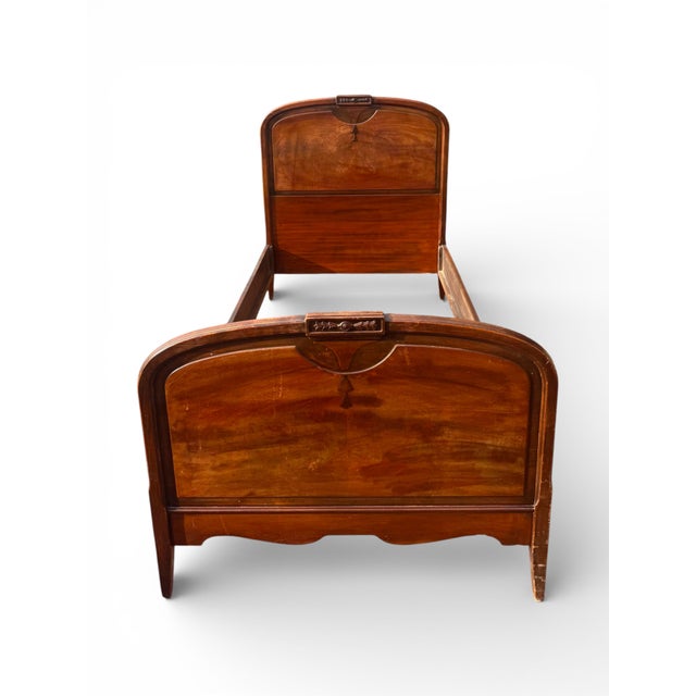 Berkey & Gay Furniture twin bed frame with a softly arched headboard and footboard, decorative crest detail, and tapered...