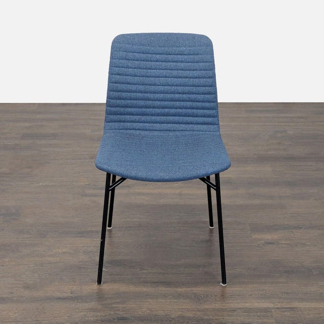 The Cato chair is channel tufted in Medley Ink upholstery on steel legs. The architectural shape of the base and the...