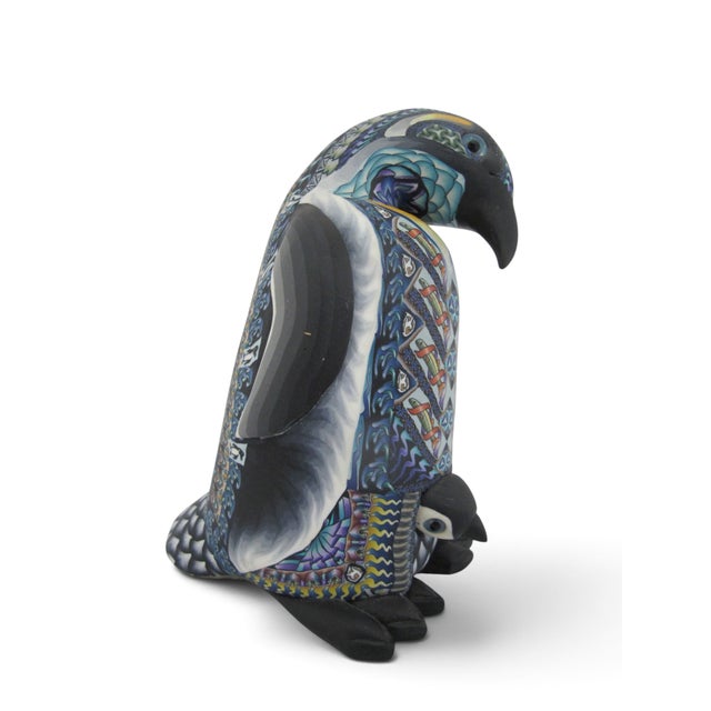 Handcrafted polymer clay sculpture of a mother penguin and her chick, created by artist Jon Stuart Anderson, Fimo...