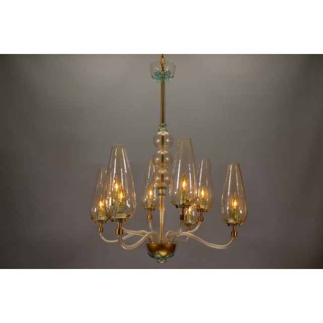 Rare 1970s murano chandelier with golden accents – a striking statement piece of italian design. A stunning italian murano...