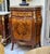 Elegant Louis XVI style commode cabinet featuring a refined beige marble top and exquisite marquetry craftsmanship with...